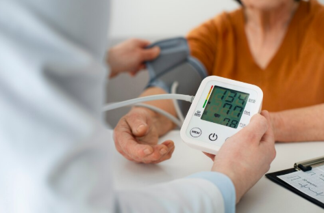 Close-up of prescribed blood pressure pills and a glass of water.