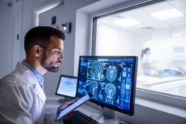 **Alt Text:** Radiologist viewing digital scans like X-rays and MRIs on a screen — highlighting advanced imaging technology used for accurate diagnosis in modern radiology.